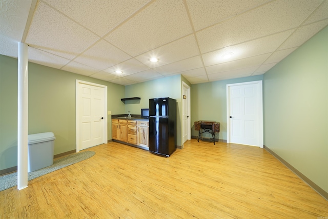 505 E Tri Lks, Horseshoe Bend, AR 72512 - kitchen featuring freestanding refrigerator, dark countertops, light wood-style floors, baseboards, and a sink
