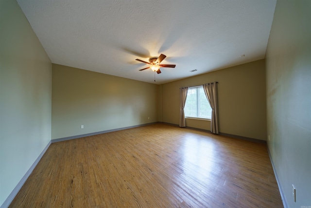 505 E Tri Lks, Horseshoe Bend, AR 72512 - empty room featuring ceiling fan, wood finished floors, and baseboards