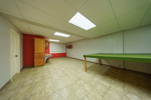 505 E Tri Lks, Horseshoe Bend, AR 72512 - finished below grade area with a drop ceiling, an AC wall unit, baseboards, and light floors