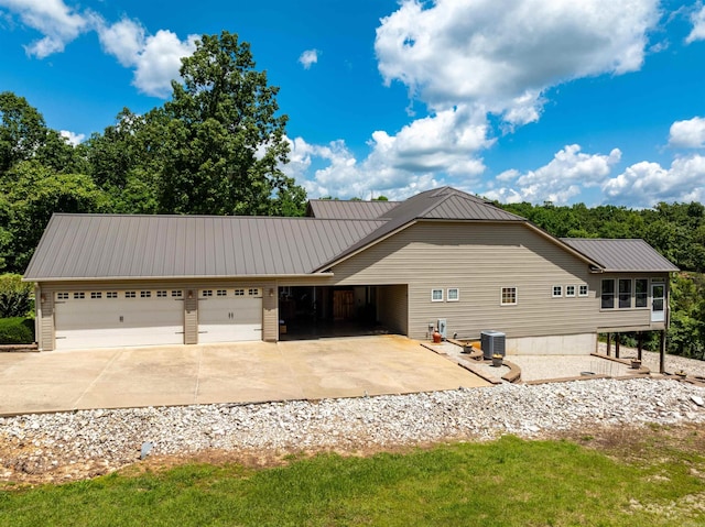 505 E Tri Lks, Horseshoe Bend, AR 72512 - view of home's exterior featuring driveway, an attached garage, metal roof, and central AC unit
