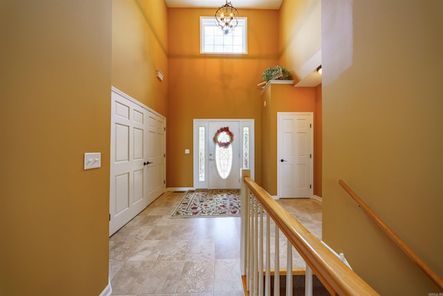 505 E Tri Lks, Horseshoe Bend, AR 72512 - foyer featuring a chandelier, a high ceiling, and baseboards