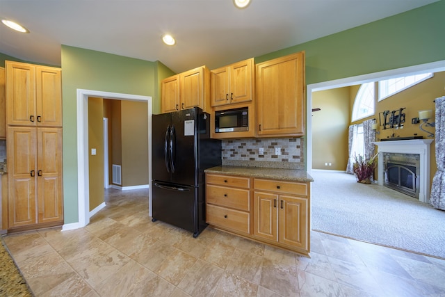 505 E Tri Lks, Horseshoe Bend, AR 72512 - kitchen with freestanding refrigerator, built in microwave, baseboards, tasteful backsplash, and a fireplace
