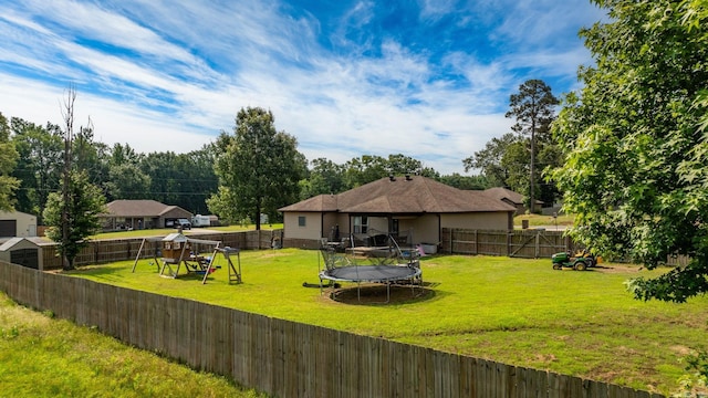 390 Bobwhite Cir, Lonoke, AR 72086 - back of house featuring a playground and a trampoline