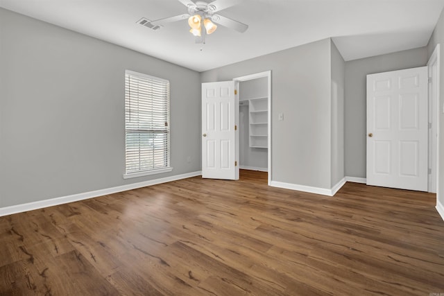 57 Deerfield Dr, Plumerville, AR 72127 - unfurnished bedroom featuring wood finished floors, a walk in closet, ceiling fan, and a closet