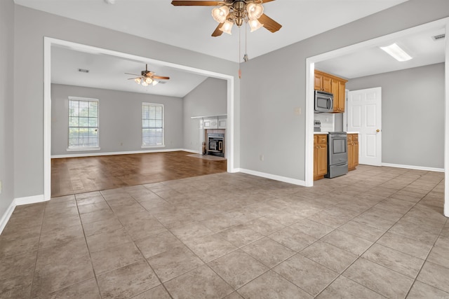 57 Deerfield Dr, Plumerville, AR 72127 - unfurnished living room featuring ceiling fan, light tile patterned floors, vaulted ceiling, and a tiled fireplace