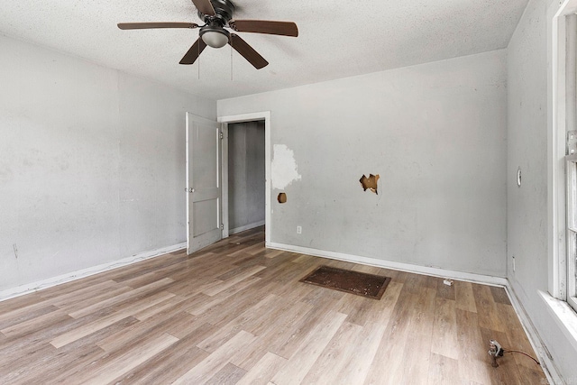 818 W 25th St, North Little Rock, AR 72114 - spare room with a ceiling fan, wood finished floors, baseboards, and a textured ceiling