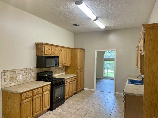 417 Ridge Rd, Pocahontas, AR 72455 - kitchen featuring black appliances, a sink, light countertops, backsplash, and a textured ceiling