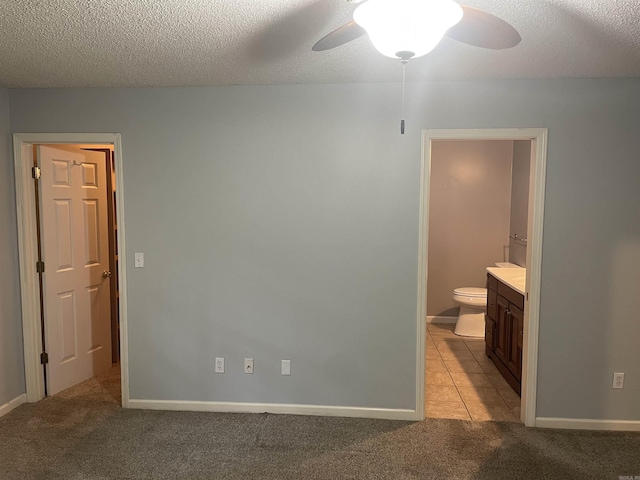 417 Ridge Rd, Pocahontas, AR 72455 - unfurnished bedroom featuring light carpet, ensuite bathroom, a ceiling fan, a textured ceiling, and baseboards