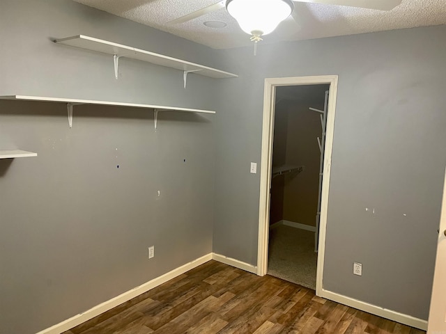 417 Ridge Rd, Pocahontas, AR 72455 - washroom with ceiling fan, dark wood-style flooring, baseboards, and a textured ceiling