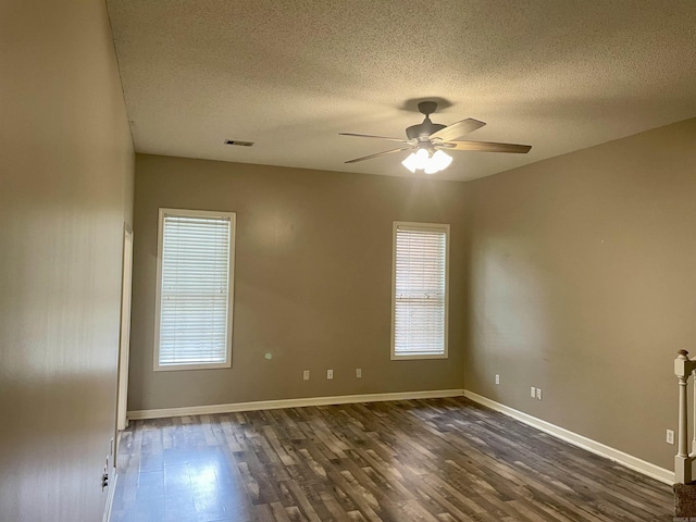 417 Ridge Rd, Pocahontas, AR 72455 - spare room with dark wood-style flooring, a textured ceiling, ceiling fan, and baseboards