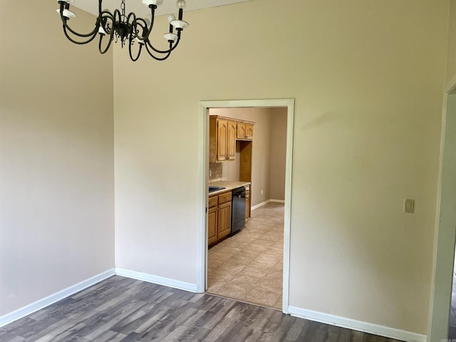 417 Ridge Rd, Pocahontas, AR 72455 - unfurnished dining area featuring a chandelier, baseboards, and wood finished floors