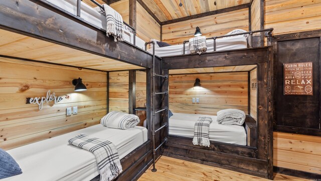 136 Gnarly Maple Trl, Hochatown, OK 74728 - bedroom featuring wood walls, hardwood / wood-style floors, and wood ceiling