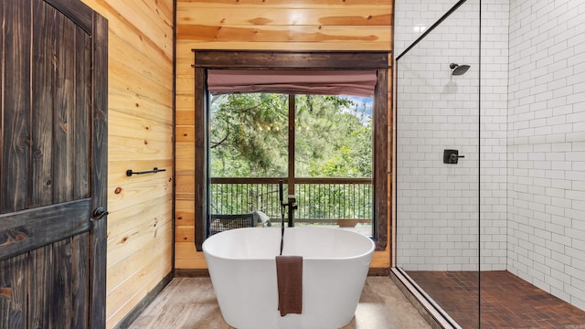 136 Gnarly Maple Trl, Hochatown, OK 74728 - bathroom featuring a tile shower, a freestanding tub, and wood walls