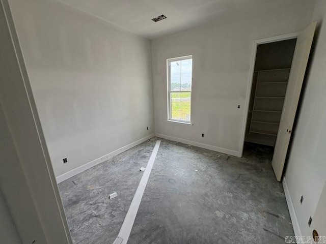 107 Barton St, Beebe, AR 72012 - unfurnished bedroom with a walk in closet, baseboards, and a closet