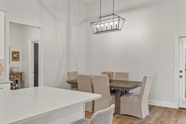107 Hidden Creek Dr, Brookland, AR 72417 - dining area featuring light wood-type flooring, a chandelier, and baseboards