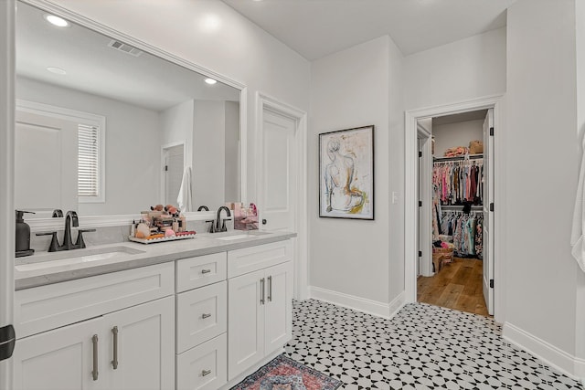 107 Hidden Creek Dr, Brookland, AR 72417 - full bath featuring double vanity, baseboards, tile patterned floors, a walk in closet, and recessed lighting