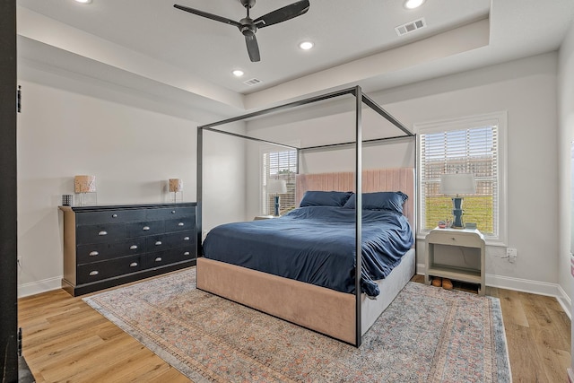 107 Hidden Creek Dr, Brookland, AR 72417 - bedroom with light wood-type flooring, baseboards, recessed lighting, a ceiling fan, and a raised ceiling