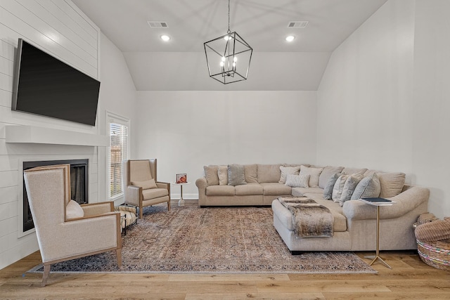 107 Hidden Creek Dr, Brookland, AR 72417 - living area with vaulted ceiling, a chandelier, a large fireplace, and wood finished floors