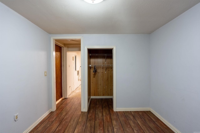 304 Main St, Letona, AR 72143 - unfurnished bedroom with dark wood-style floors, baseboards, and a closet