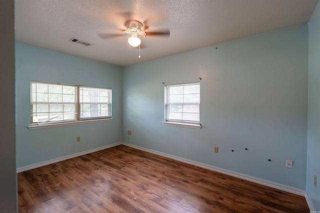 304 Main St, Letona, AR 72143 - unfurnished room featuring ceiling fan, wood finished floors, a textured ceiling, and baseboards