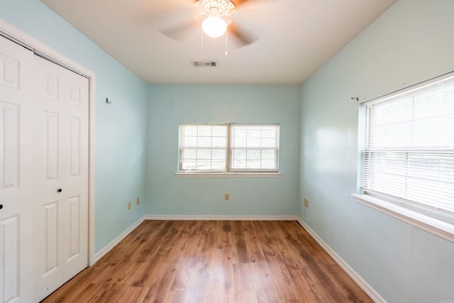 304 Main St, Letona, AR 72143 - unfurnished bedroom featuring wood finished floors, a closet, baseboards, and ceiling fan
