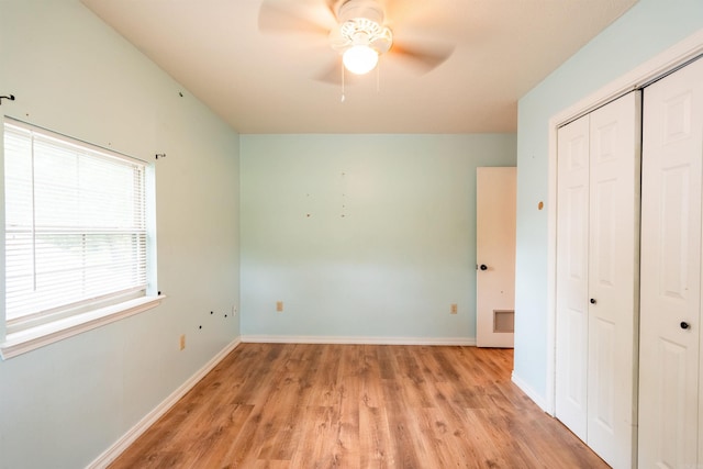 304 Main St, Letona, AR 72143 - unfurnished bedroom featuring a closet, light wood finished floors, baseboards, and a ceiling fan
