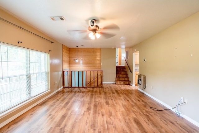 304 Main St, Letona, AR 72143 - unfurnished living room with light wood-style flooring, baseboards, a ceiling fan, and heating unit