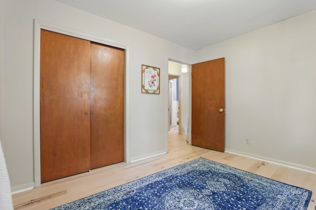 415 W 50th St, North Little Rock, AR 72118 - unfurnished bedroom with wood finished floors, baseboards, and a closet