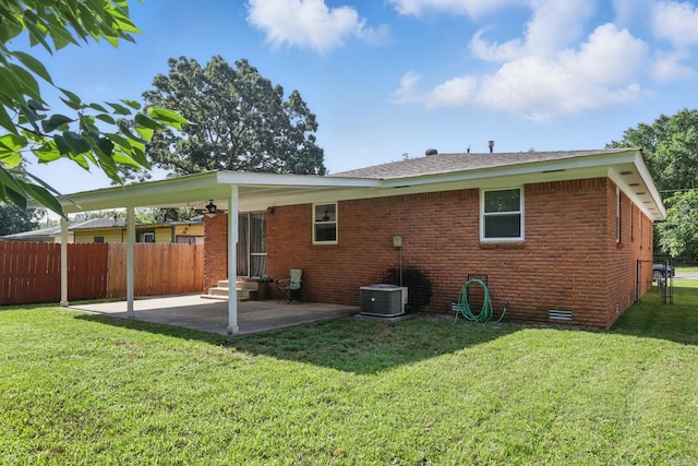415 W 50th St, North Little Rock, AR 72118 - rear view of house with a patio, brick siding, entry steps, and central AC