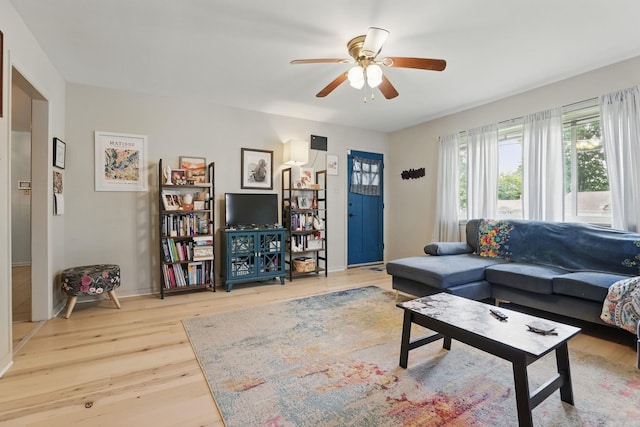415 W 50th St, North Little Rock, AR 72118 - living area with wood finished floors, a ceiling fan, and baseboards