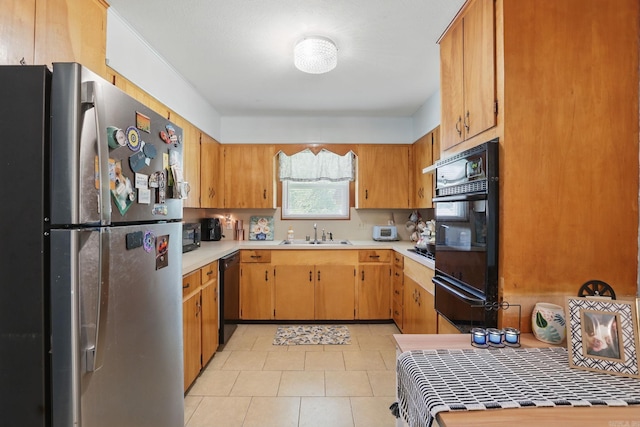 415 W 50th St, North Little Rock, AR 72118 - kitchen with black appliances, a warming drawer, a sink, and light countertops