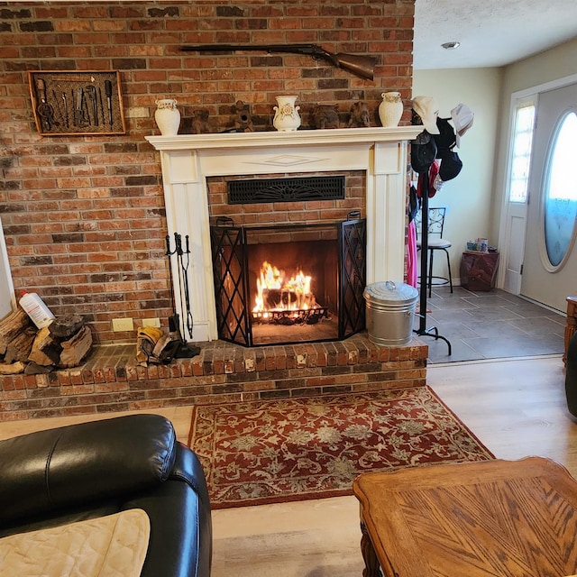 110 Emerald Ln, Horseshoe Bend, AR 72512 - detailed view of a brick fireplace, baseboards, and wood finished floors