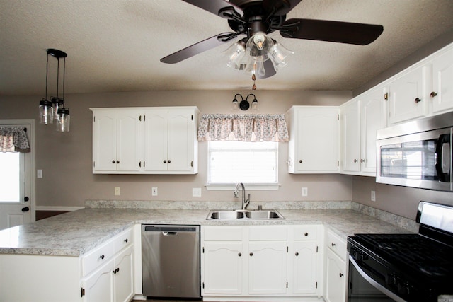 2118 Cedar Rdg, Benton, AR 72015 - kitchen with stainless steel appliances, a sink, a peninsula, ceiling fan, and white cabinetry
