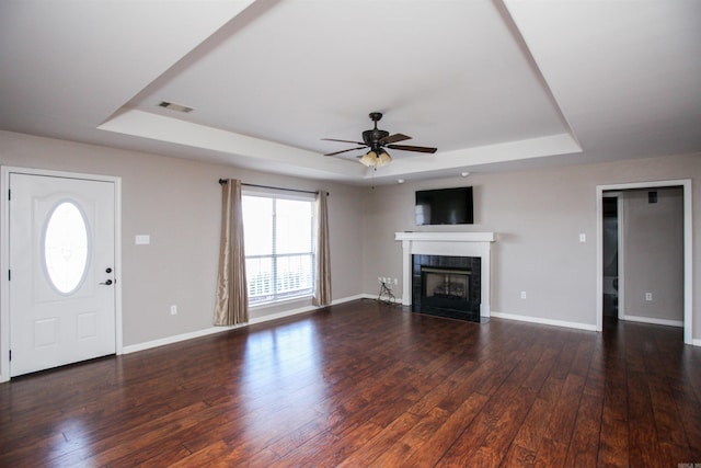2118 Cedar Rdg, Benton, AR 72015 - unfurnished living room featuring a raised ceiling, a ceiling fan, a tile fireplace, and baseboards