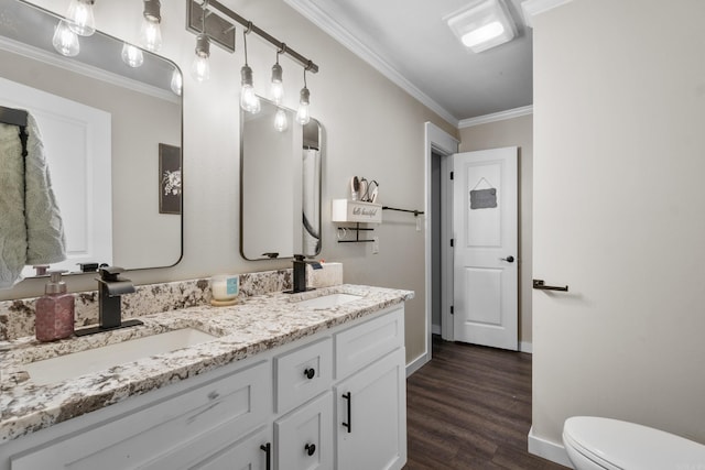 3101 Lax St, Newport, AR 72112 - bathroom with double vanity, ornamental molding, toilet, wood finished floors, and baseboards