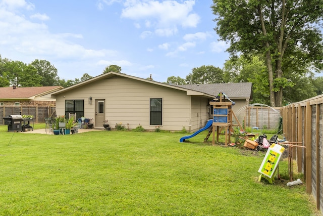 3101 Lax St, Newport, AR 72112 - rear view of house featuring a playground, a patio area, and a shingled roof