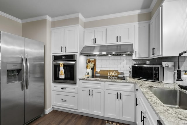 3101 Lax St, Newport, AR 72112 - kitchen featuring appliances with stainless steel finishes, under cabinet range hood, ornamental molding, white cabinetry, and dark wood-type flooring