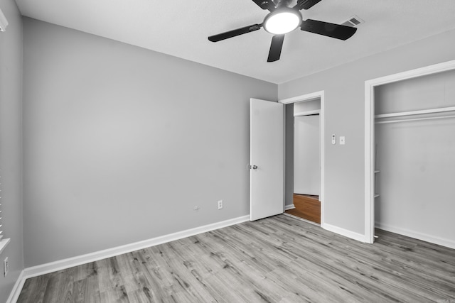 12224 Shawnee Forest Dr, Little Rock, AR 72212 - unfurnished bedroom with wood finished floors, a closet, and baseboards