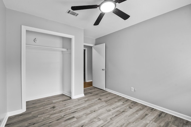 12224 Shawnee Forest Dr, Little Rock, AR 72212 - unfurnished bedroom with wood finished floors, a closet, baseboards, and a ceiling fan