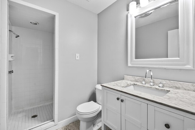 12224 Shawnee Forest Dr, Little Rock, AR 72212 - bathroom featuring vanity, toilet, and a stall shower