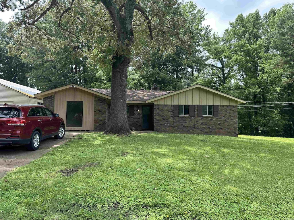 51 Sfc 445, Forrest City, AR 72335 - single story home with a front lawn, brick siding, and view of scattered trees