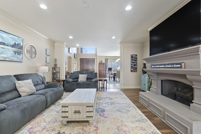 26 Jacob Pl, Little Rock, AR 72211 - living area with ornamental molding, recessed lighting, a fireplace with raised hearth, baseboards, and dark wood-type flooring