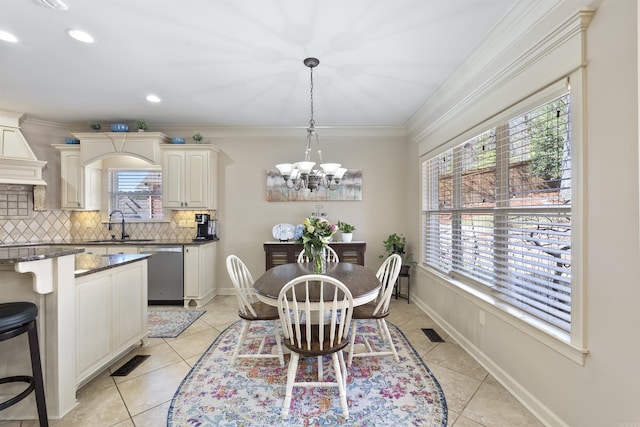 26 Jacob Pl, Little Rock, AR 72211 - dining space featuring a chandelier, light tile patterned floors, recessed lighting, crown molding, and baseboards