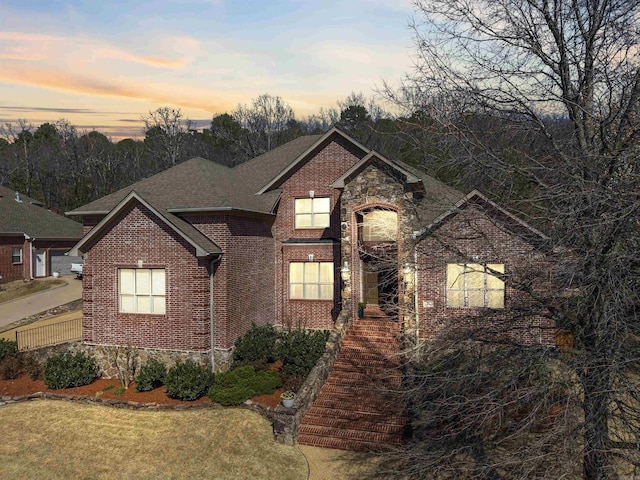 26 Jacob Pl, Little Rock, AR 72211 - view of front of home with brick siding, a shingled roof, and stone siding
