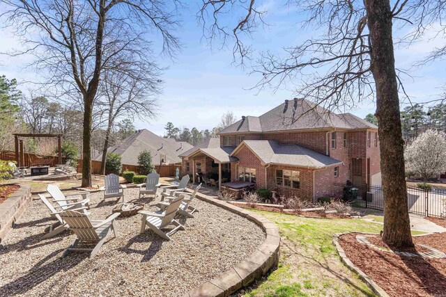 26 Jacob Pl, Little Rock, AR 72211 - fenced yard featuring an outdoor fire pit, a patio area, and a jacuzzi
