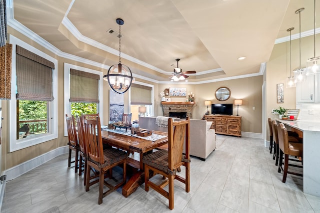 490 Quail Rdg, Hot Springs, AR 71901 - dining space featuring a tray ceiling, baseboards, a fireplace, a chandelier, and ceiling fan