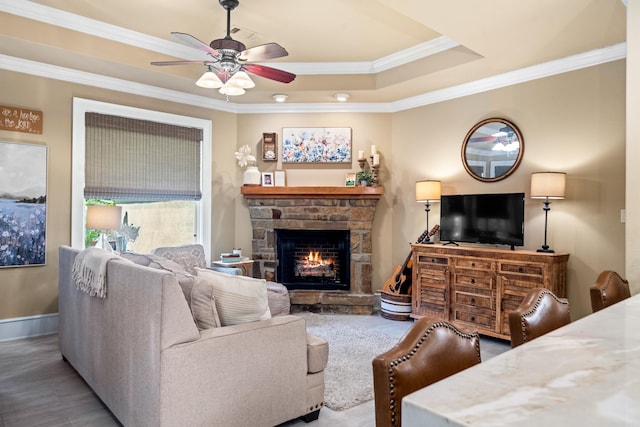 490 Quail Rdg, Hot Springs, AR 71901 - living area with crown molding, a stone fireplace, ceiling fan, baseboards, and wood finished floors