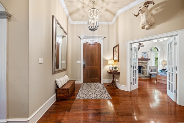 490 Quail Rdg, Hot Springs, AR 71901 - entryway featuring a chandelier, wood-type flooring, crown molding, a stone fireplace, and baseboards
