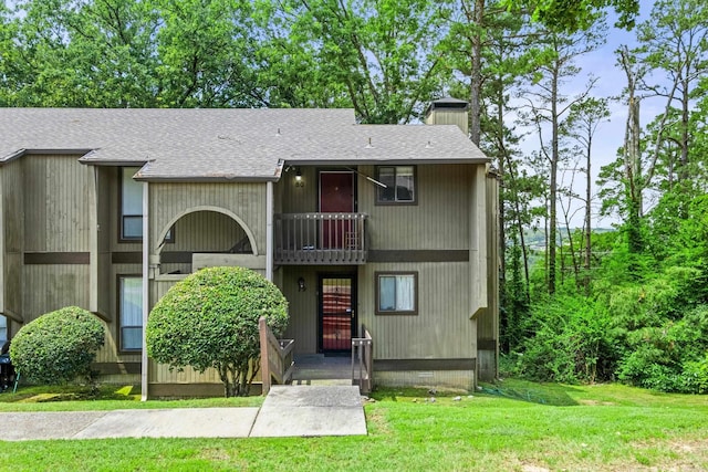 508 Green Mountain Cir Unit 80, Little Rock, AR 72211 - view of front of property featuring a balcony, roof with shingles, a front lawn, and a chimney