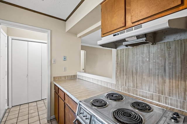 508 Green Mountain Cir Unit 80, Little Rock, AR 72211 - kitchen featuring under cabinet range hood, crown molding, range, brown cabinets, and light tile patterned floors